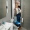 A plumber fitting pipework under a bathroom sink